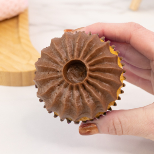 Piped chocolate buttercream mane on a cupcake using the sultan piping tip. Step 1.