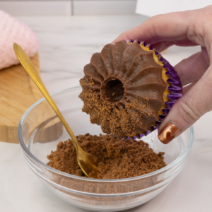 Adding crushed chocolate biscuits crumbs to the buttercream. Step 2.