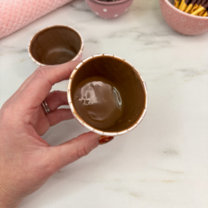 Chocolate candy melts spooned into cupcake liners to form edible wrappers