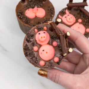 Finished pigs in mud cupcakes with piped trotters and optional Oreo crumb topping