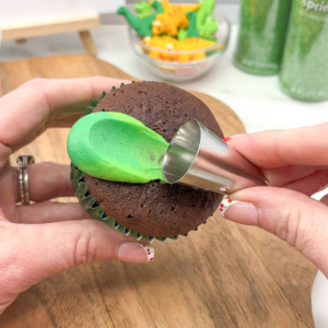 Creating buttercream frill using pipe and swipe technique around the edge of the cupcake. Step 2.