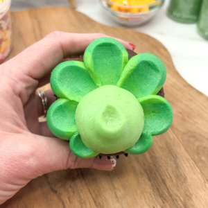 A dome of pale green buttercream for the dinosaurs face. Step 6.