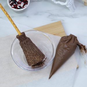 Adding more layers of chocolate drizzle on the wider end of the cone for texture.
