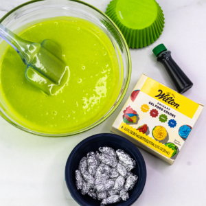 Green cupcake batter and bowl with gel colours