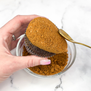 using a spoon to flatten the crumbs