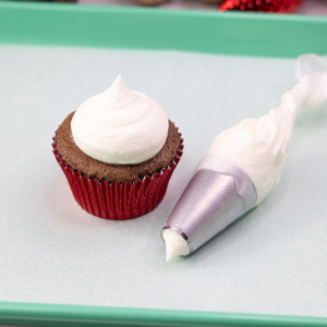 White buttercream piped onto a cupcake.