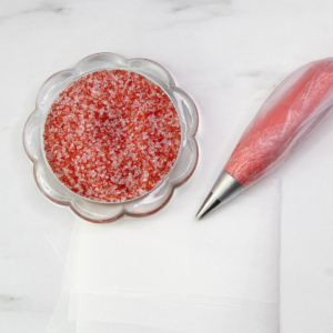 A bowl of red sanding sugar.