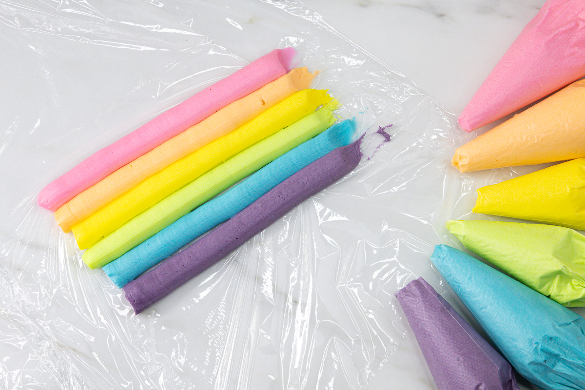 Five-colour buttercream wrapped in cling film to create a multicoloured buttercream sausage.